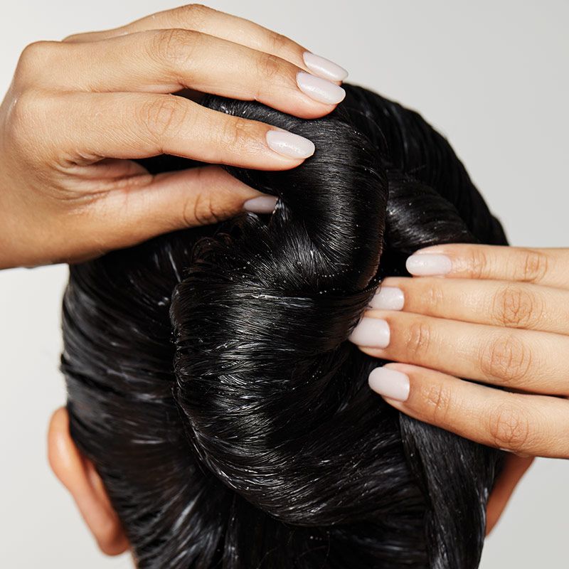macro image of a person twiting their hair into a bun
