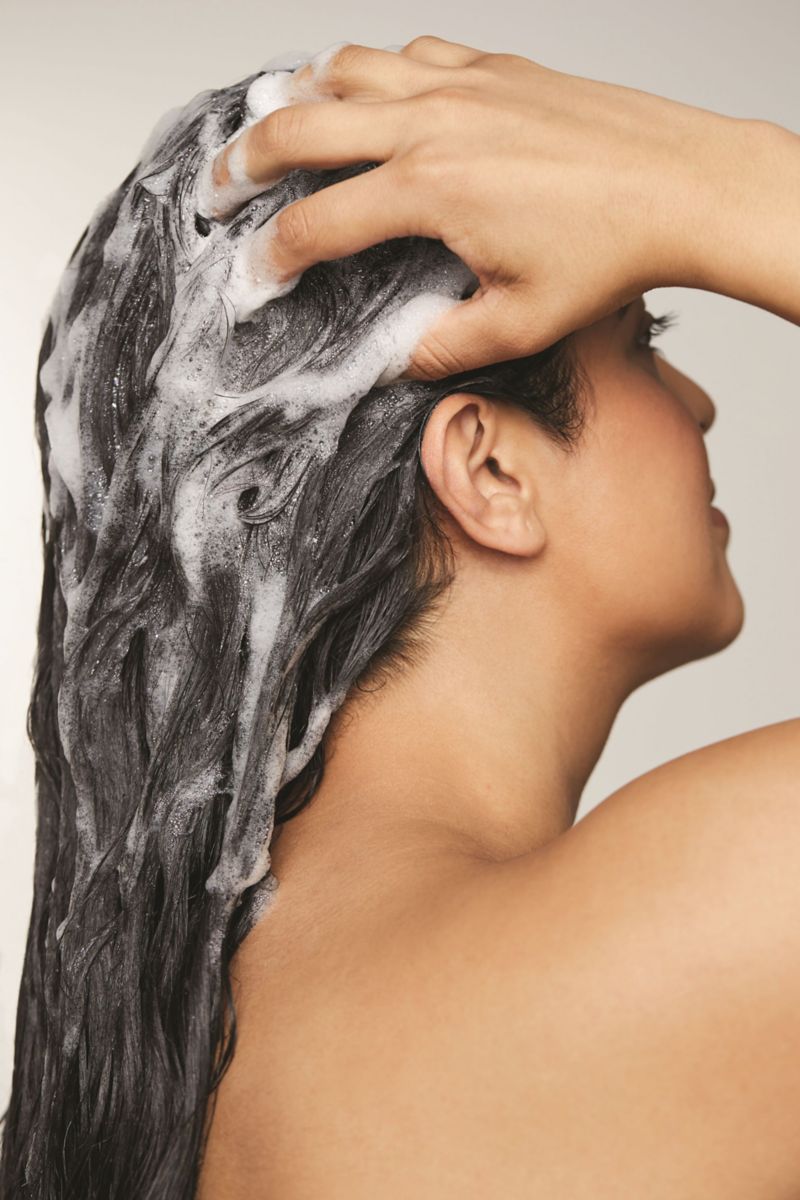 image of a woman shampooing her hair