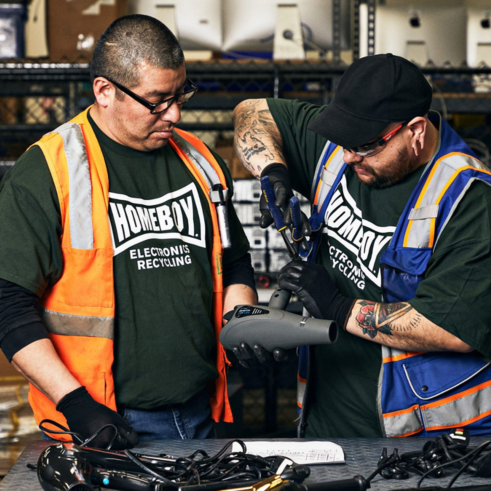 image of two Homeboy Industries employees preparing a Neuro hair dryer for recycling