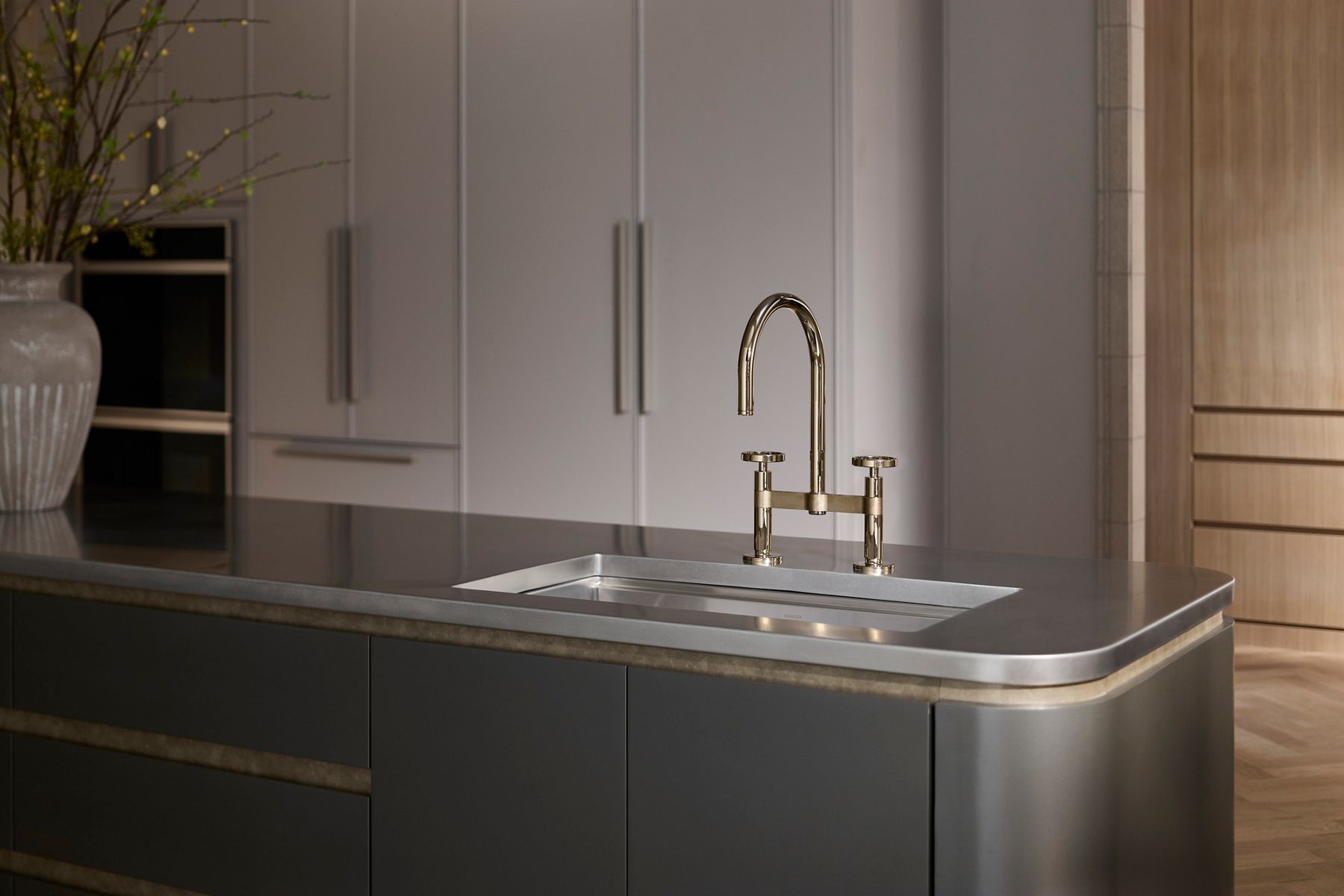 Sleek stainless steel kitchen sink with modern faucet and integrated cabinetry.