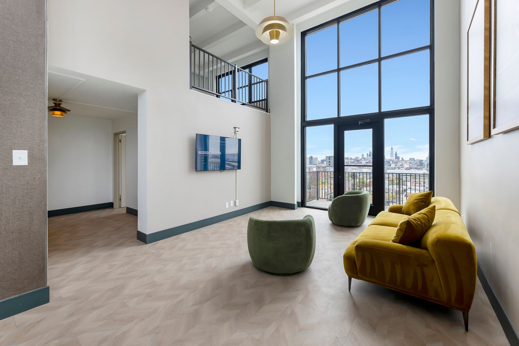Apartment lobby with cream tiled flooring, gray walls, and modern decor.
