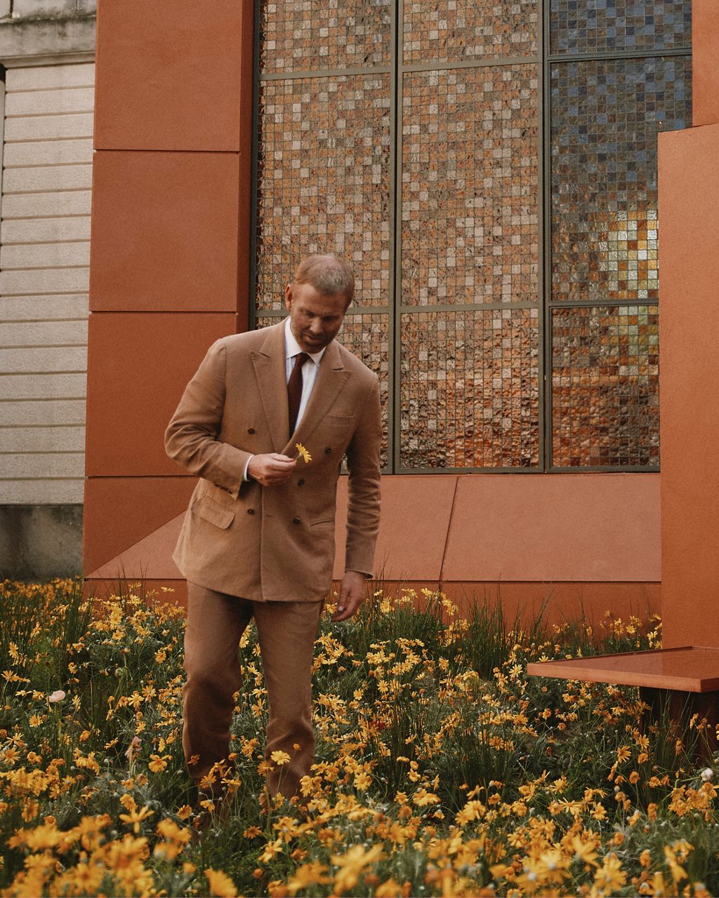 Richard Christiansen, Founder of Flamingo Estate, walks amongst the wildflowers at The Flamingo Estate Bathhouse by Kohler at Milan Design Week 2026.