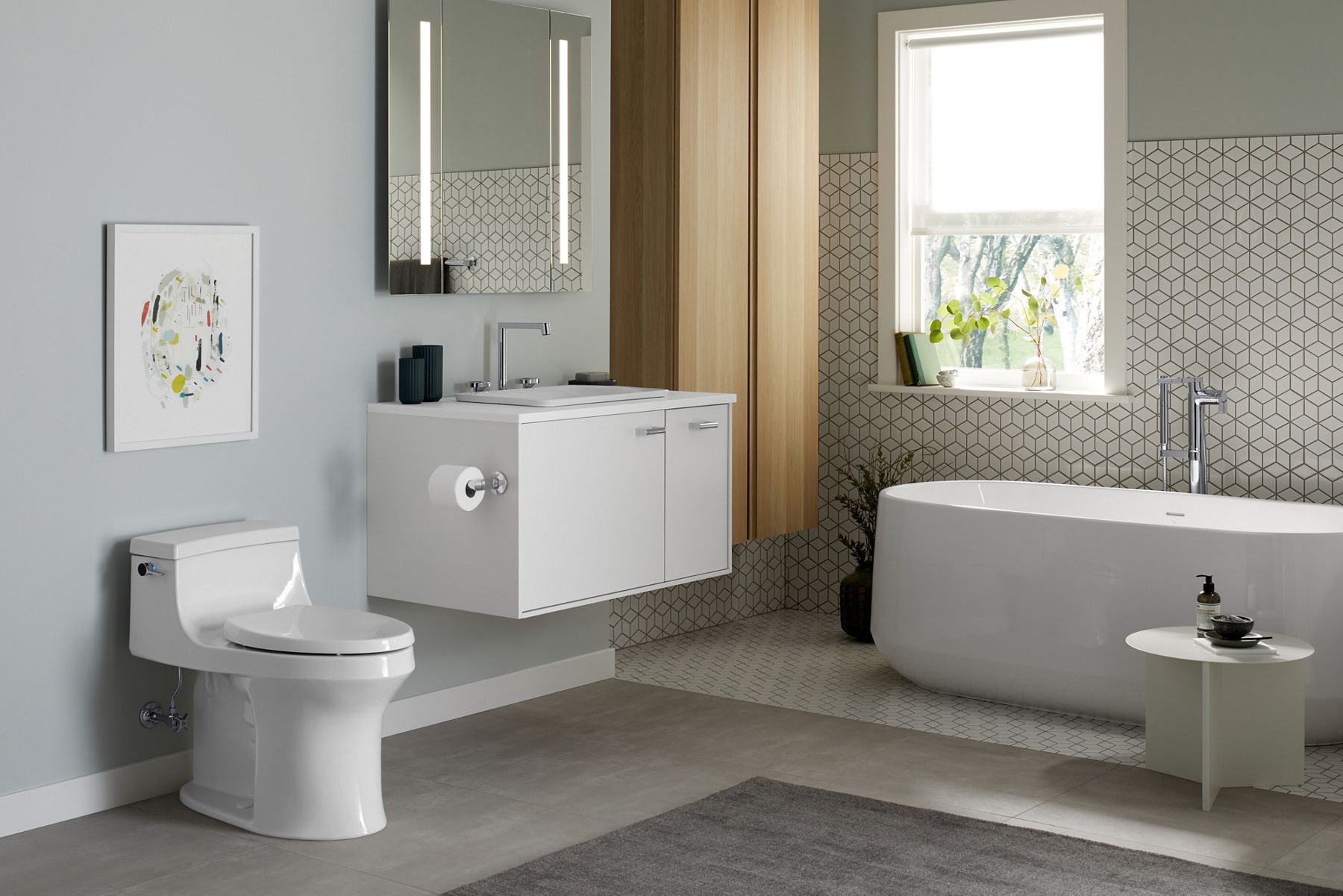 Contemporary  nuanced neutral bathroom with KOHLER toilet, vanity, faucet, and bathtub