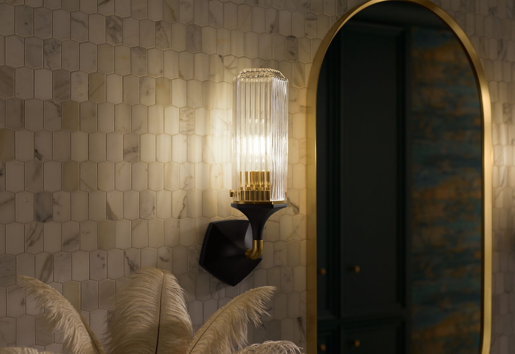 A KOHLER Occasion wall sconce complements an Occasion capsule mirror.