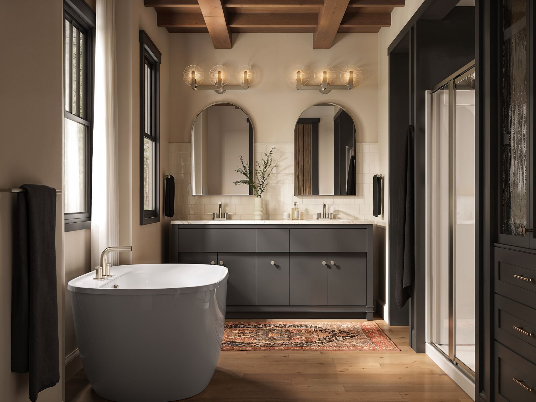Modern bathroom with wood flooring and ceiling beams, a gray freestanding stub, and a dark gray vanity.