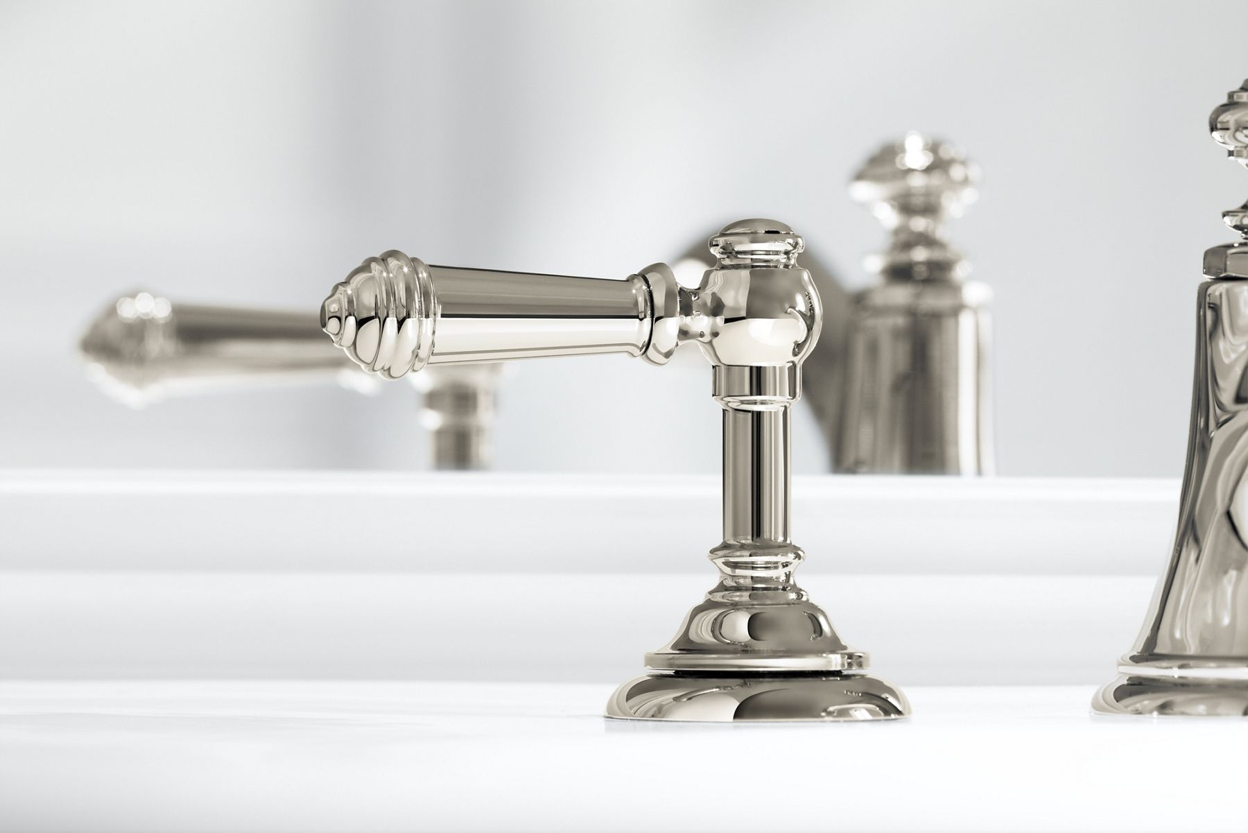 Closeup of KOHLER Artifacts widespread bathroom sink lever handles with Vibrant Polished Nickel finish