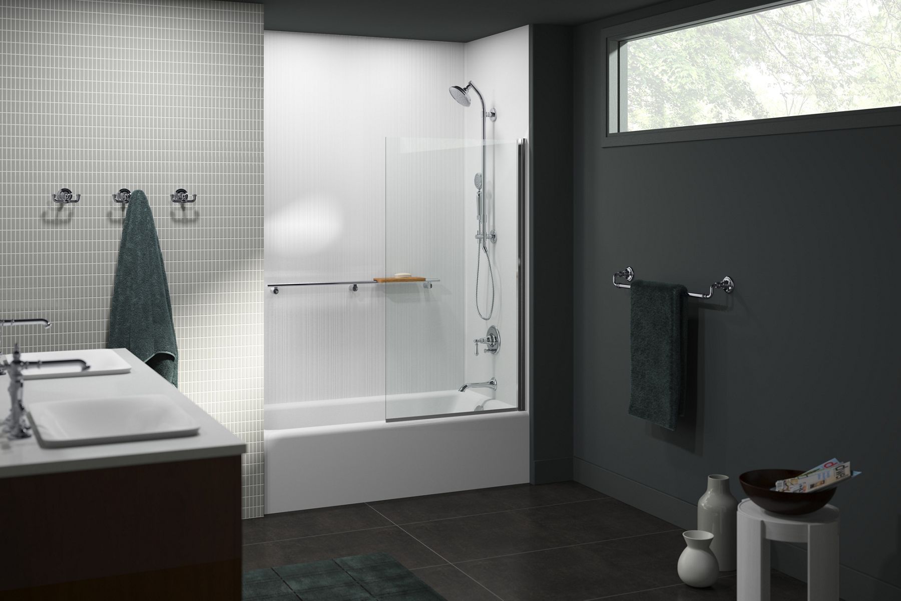 A bathroom with a double vanity on the left, white bath and shower area in the middle and a dark gray wall with a towel and window above on the right.