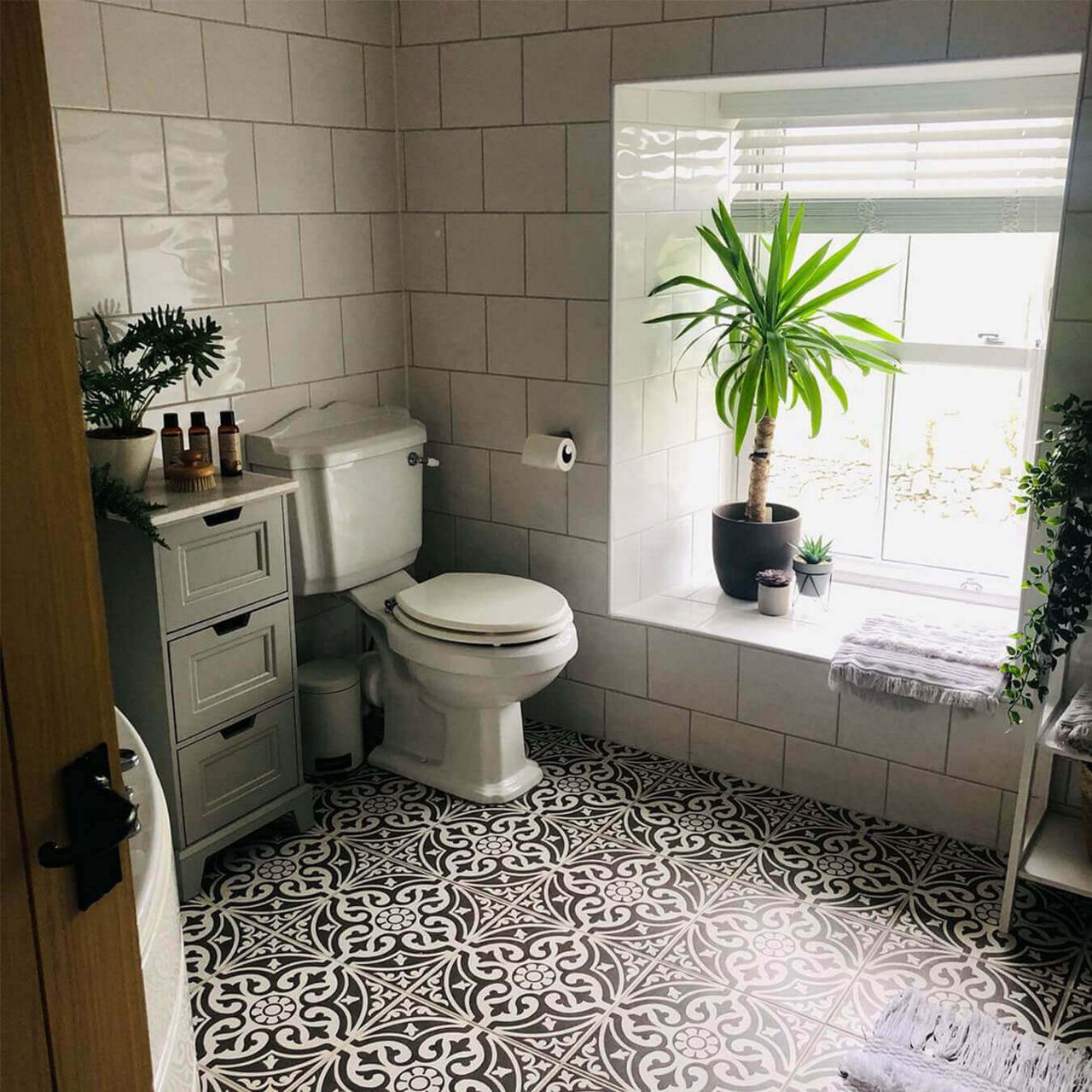 An after picture of @shelley_clegirfarm's renovated bathroom with black and white floor tiles and traditional-style furniture.