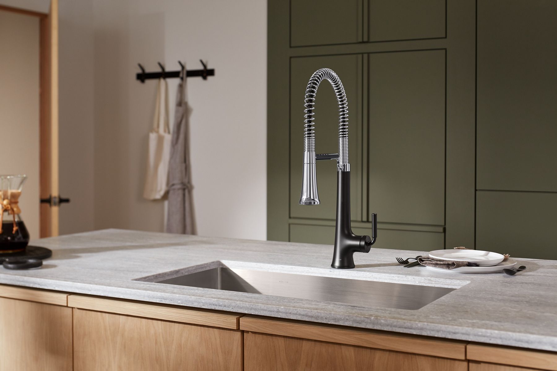 A close up shot of a black and silver sink faucet.
