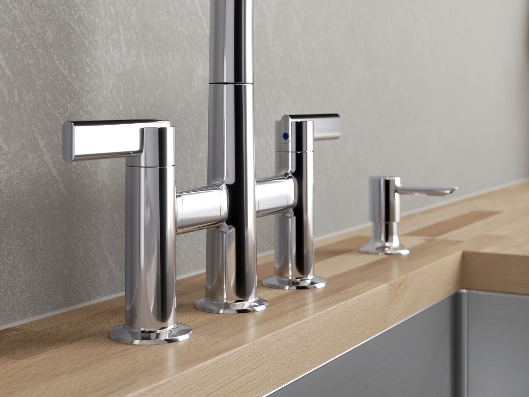 A close up shot of a polished silver sink faucet with a single lever.