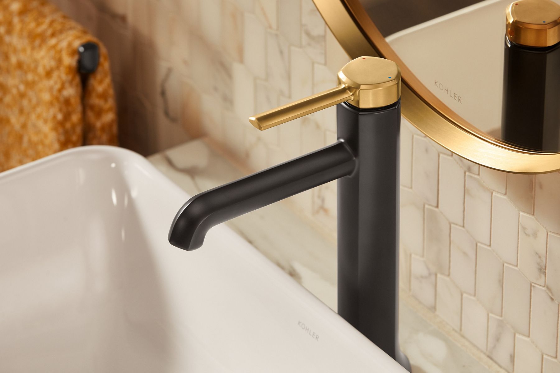 Overhead angled view of a faucet in matte black and brushed moderne brass two tone finish.