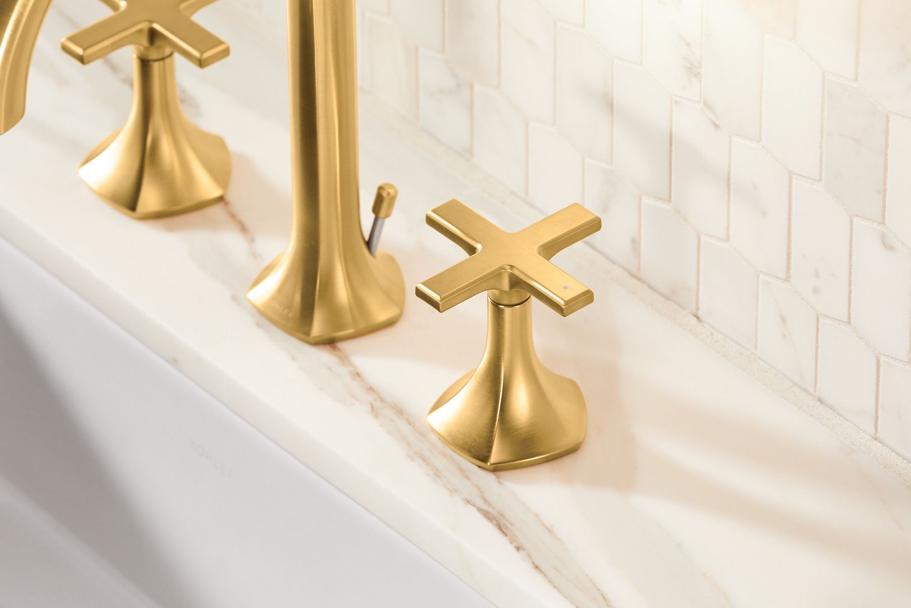 Close up of a faucet in brushed moderne brass.