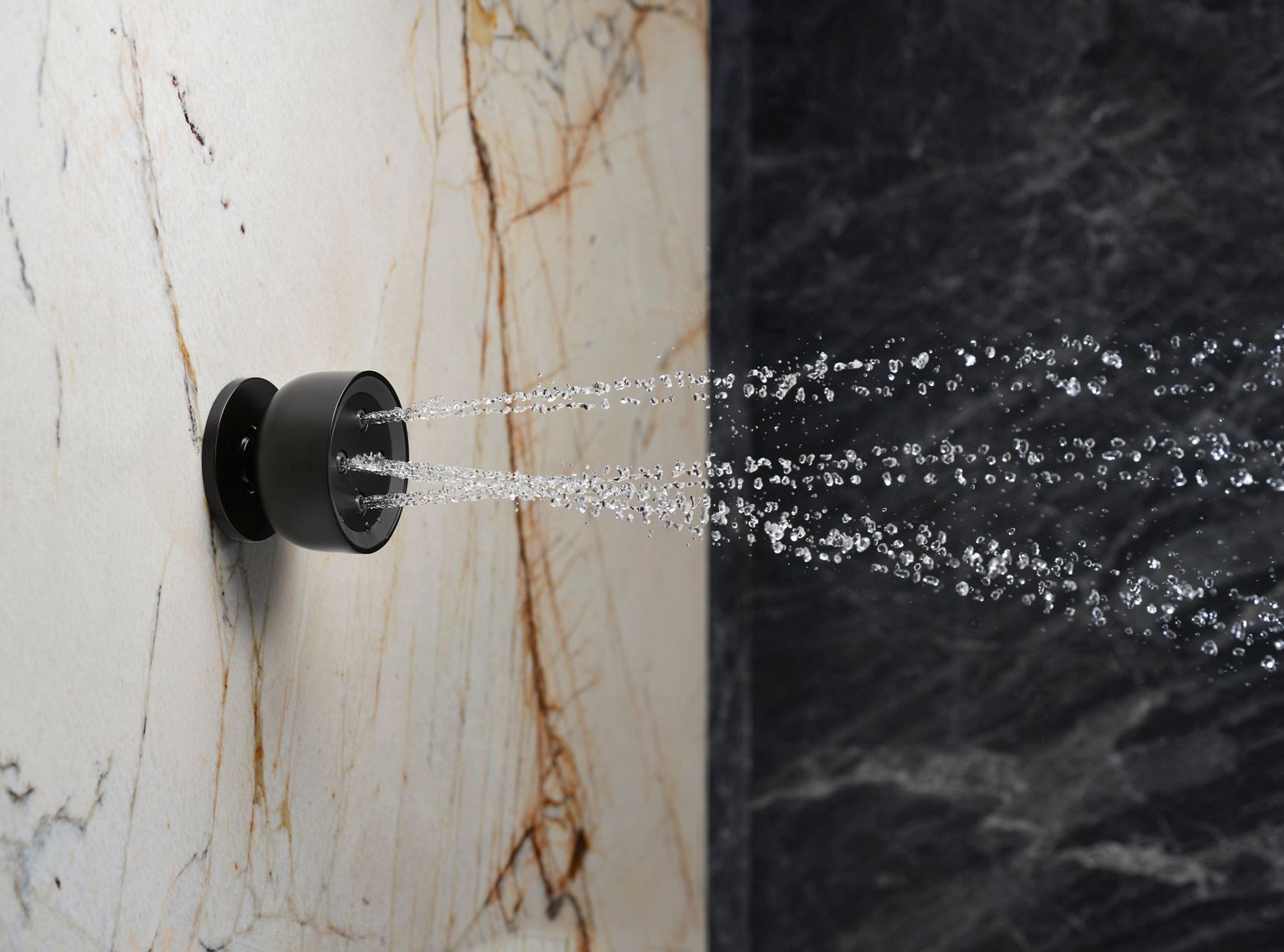  Close-up detail of a body spray with water coming out of it.