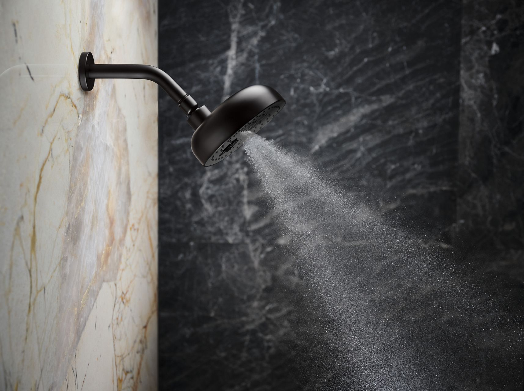 Close-up detail of a showerhead with water coming out of it.