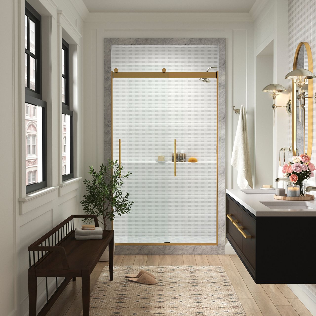 Elegant bathroom with a large glass shower enclosure featuring gold trim and handles. The shower has a white textured wall, and the room includes a black vanity, a white countertop, a towel rack, and a small potted plant.