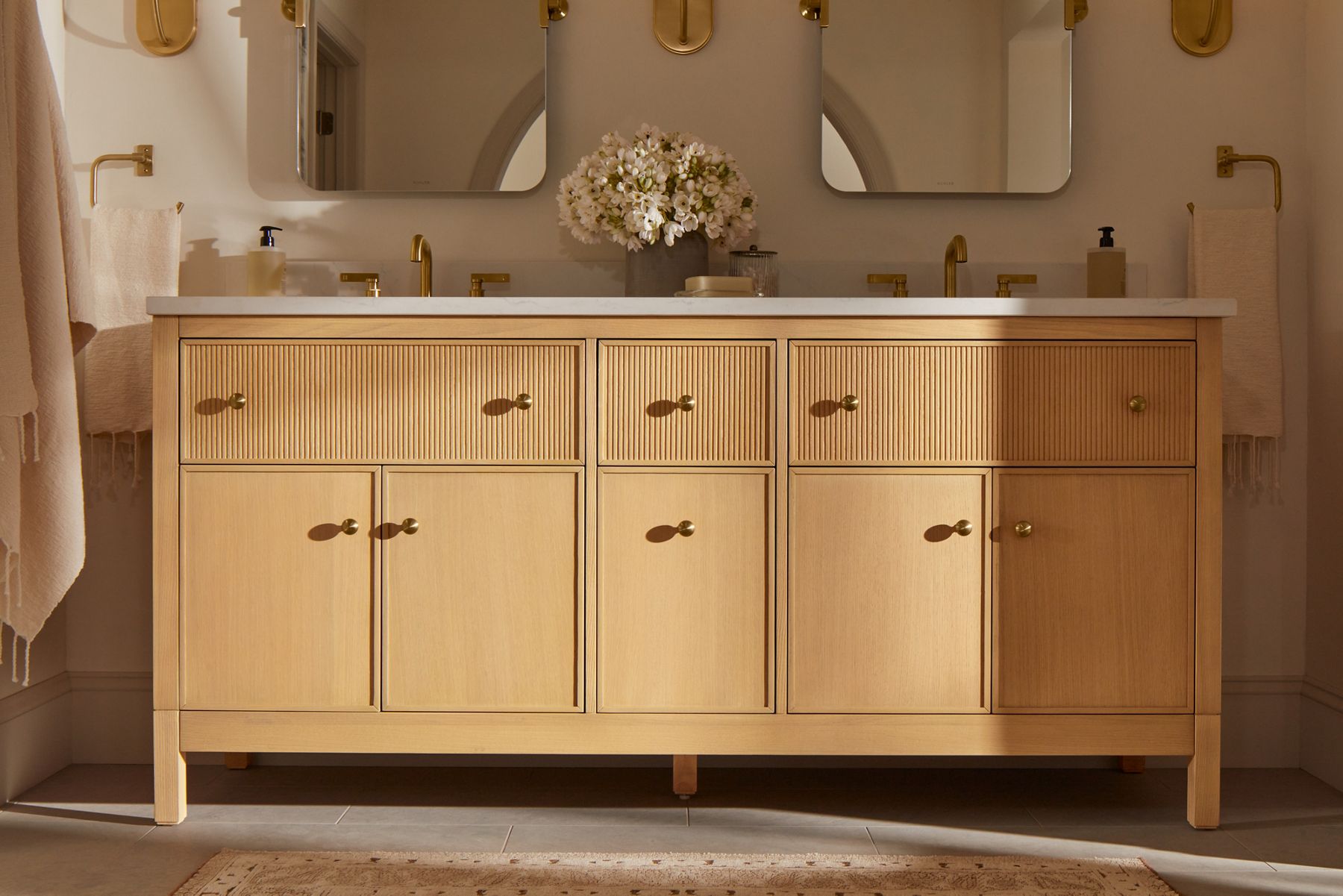 A light wood grain double bathroom vanity designed by Shea McGee.