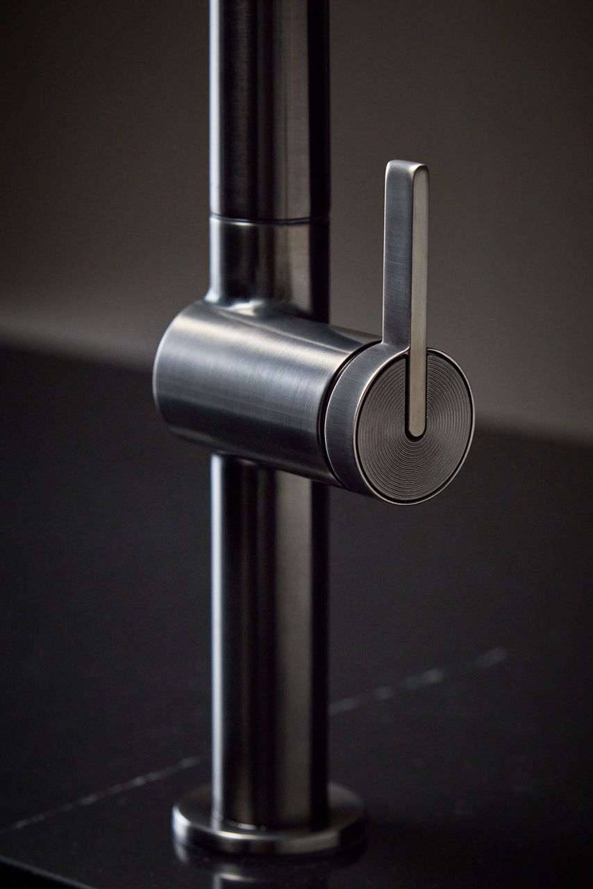 Close-up of a vibrant brushed graphite kitchen faucet