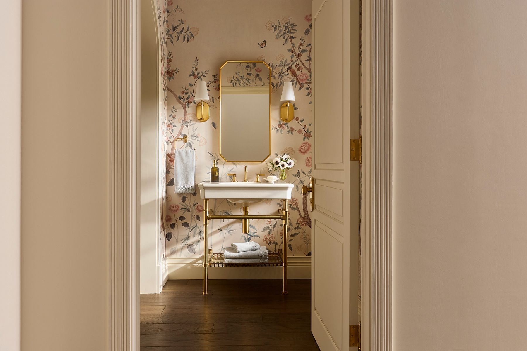 Claude by Studio McGee rectangular console table bathroom sink in gold with matching gold finishes on the mirror and faucet.