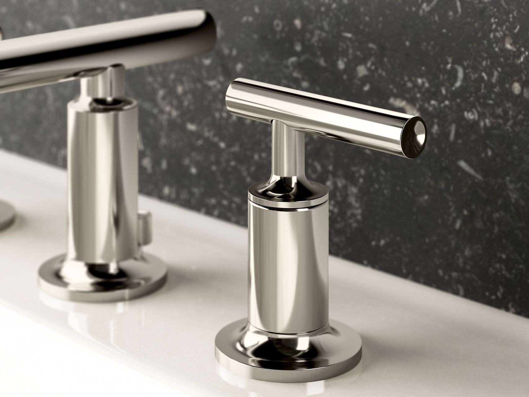 Close up of a faucet handle in polished nickel.