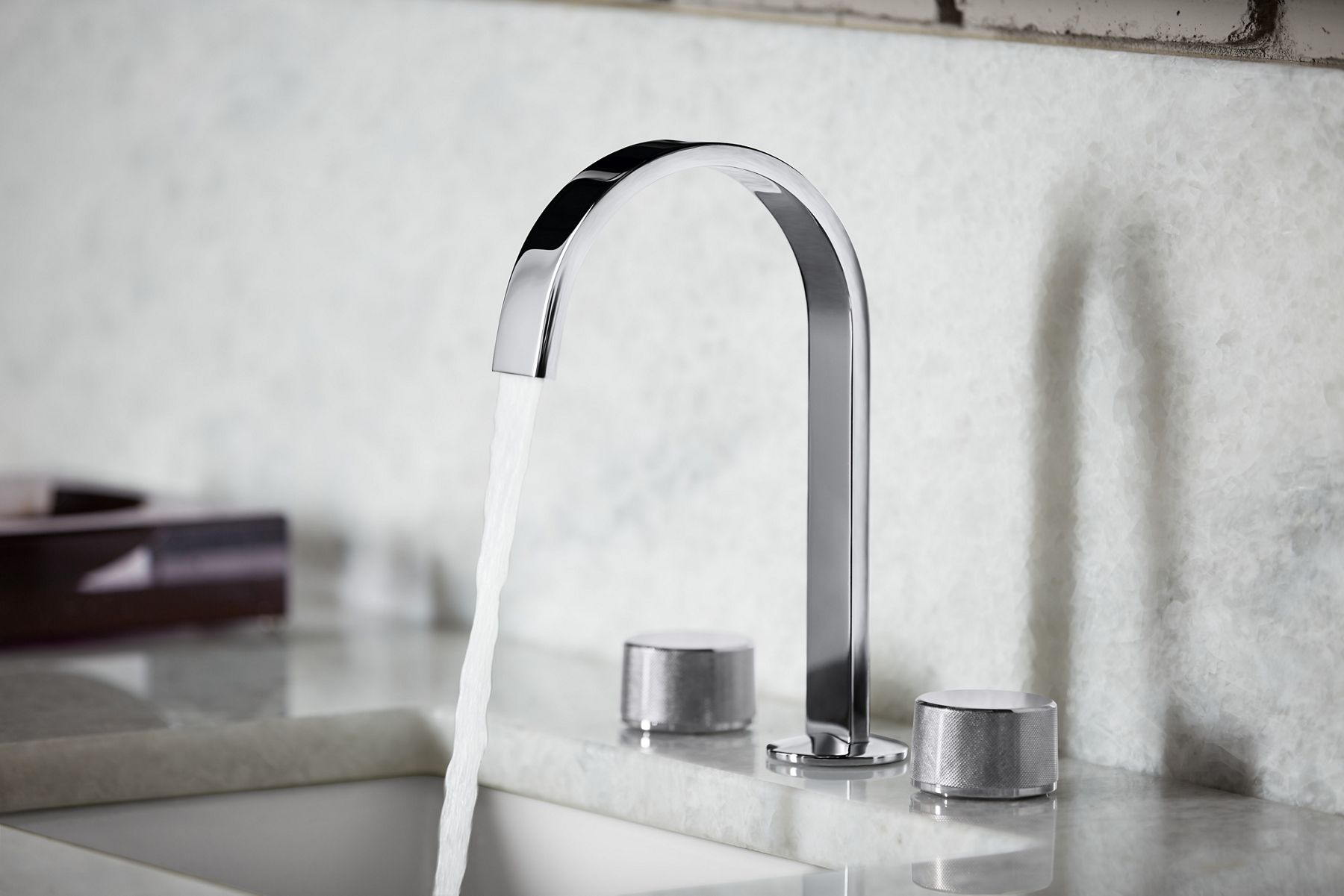 Close up of a faucet in polished chrome.