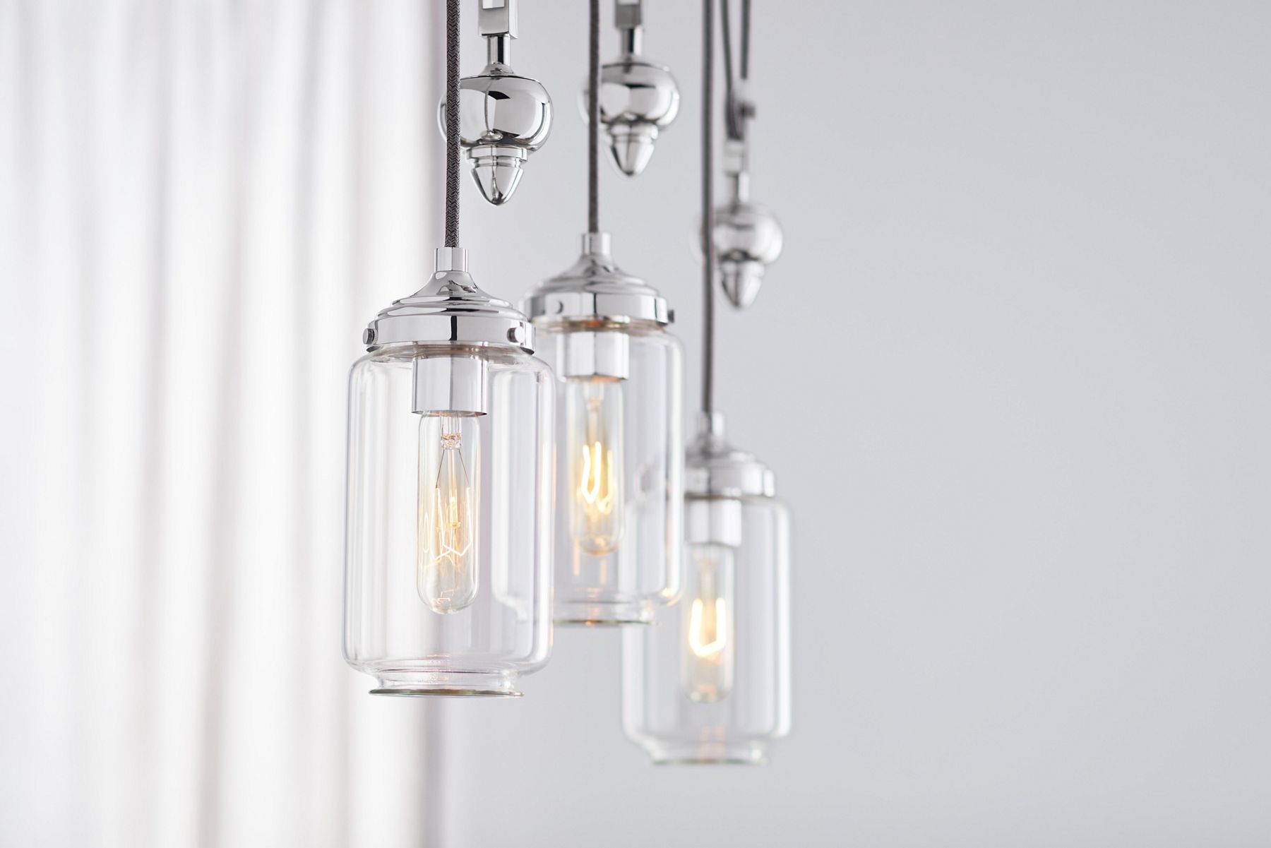 An Artifacts three-light adjustable linear chandelier.