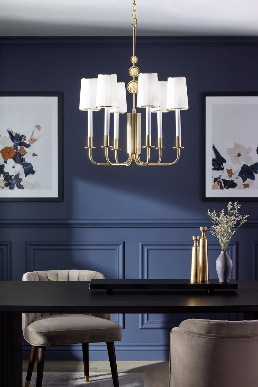A Tredous six-light chandelier in Polished Brass in a room with blue walls.