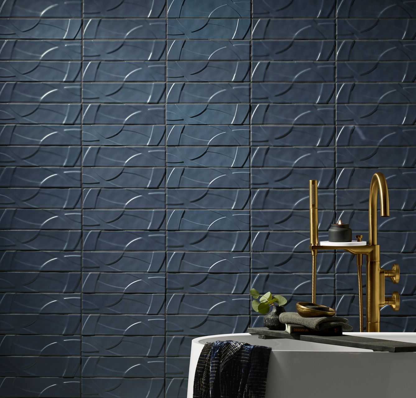 KOHLER WasteLAB® Abstra® Tile Collection showcasing blue textured tiles with a wave-like pattern.