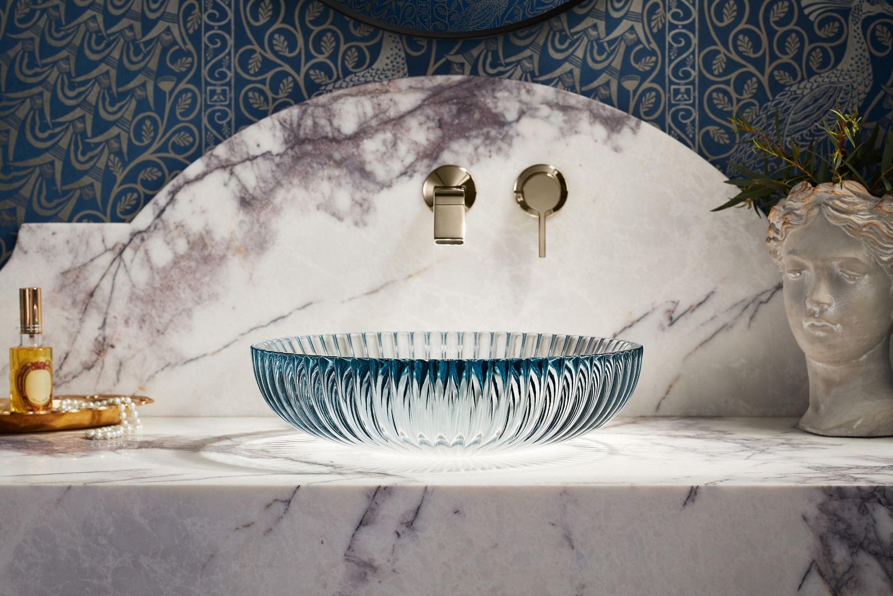 Close-up of a ribbed glass vessel sink with a scalloped edge.