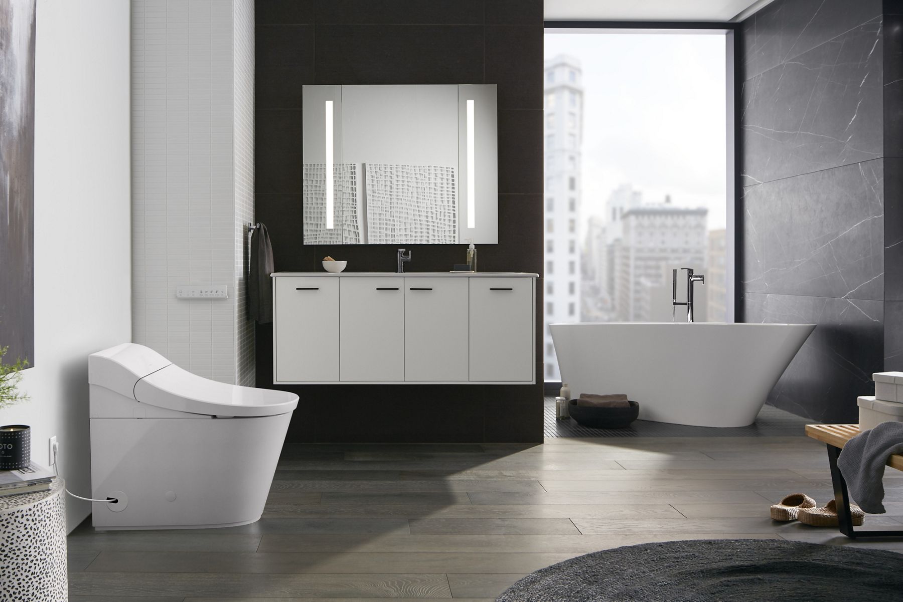 Freestanding white soaking tub with matte black faucet near tall windows.