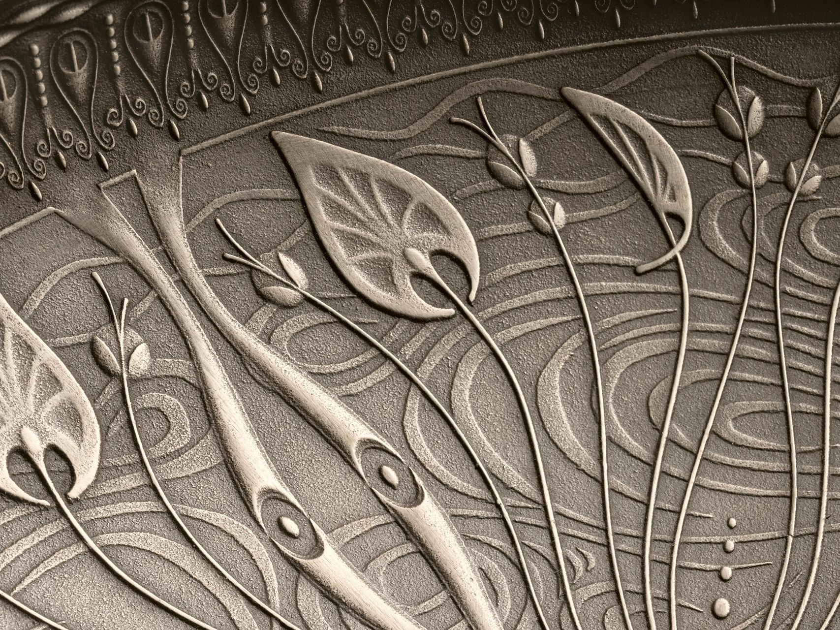 A close-up of intricate floral pattern in cast bronze