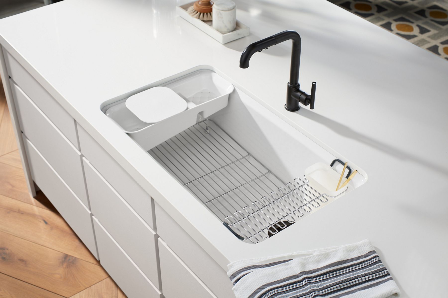 An overhead view into a white sink containing several sink racks and utility racks.
