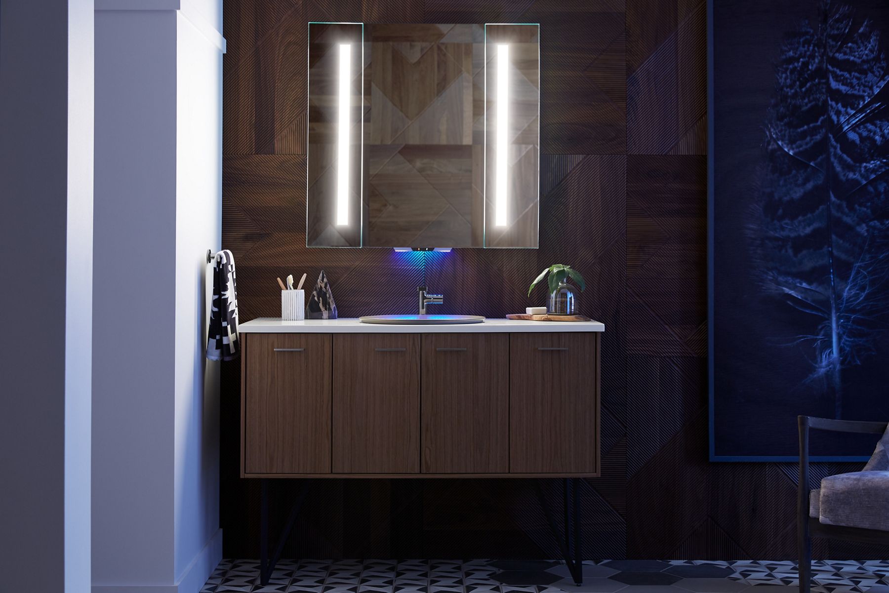 A lighted mirror with a blueish-purplish light emanating from the center bottom of the mirror to indicate that it possesses voice activation capabilities. 