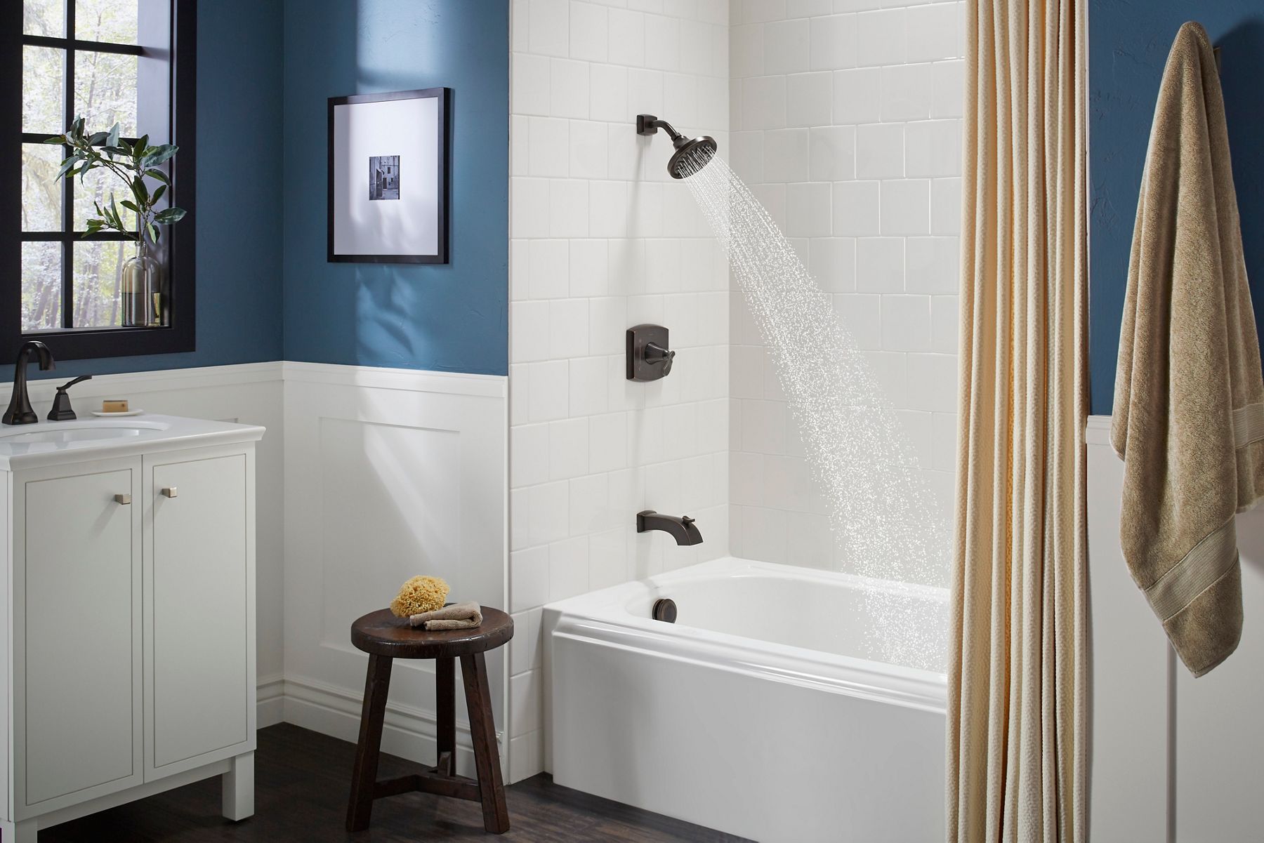 White bathtub surrounded by tiled walls and a curtain for privacy.