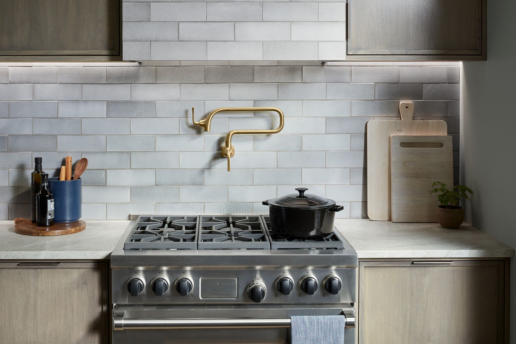 A Graze wall-mount pot filler in brushed moderne brass