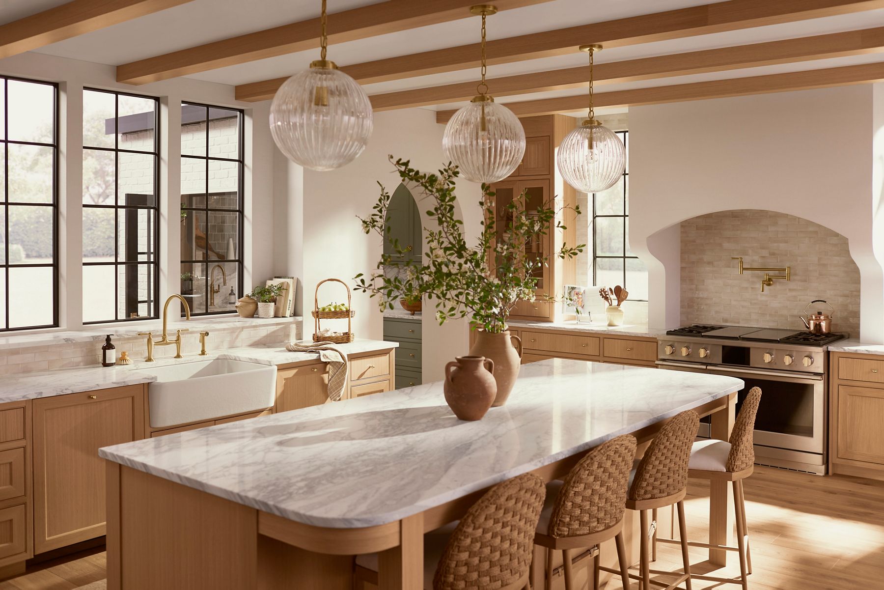 A kitchen in neutral browns and tans with a marbled stone island counter top.