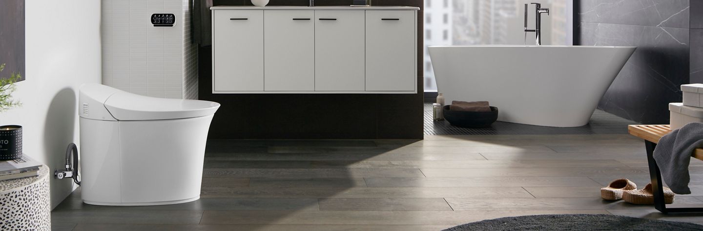A contemporary bathroom with a white Veil collection freestanding bath and smart toilet.