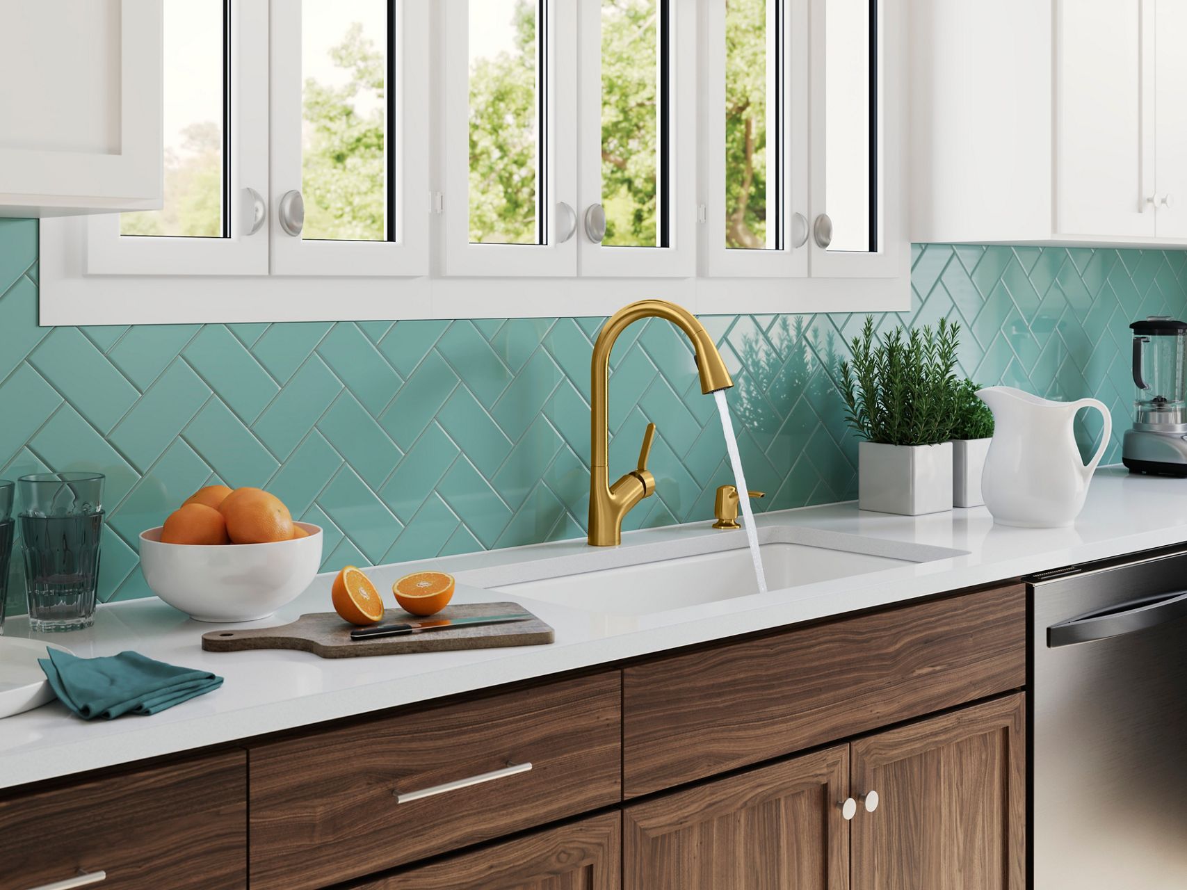 A kitchen counter with a brushed brass faucet pouring water into a white undermount sink with assorted kitchen objects on the counter and a pastel blue tile backsplash.