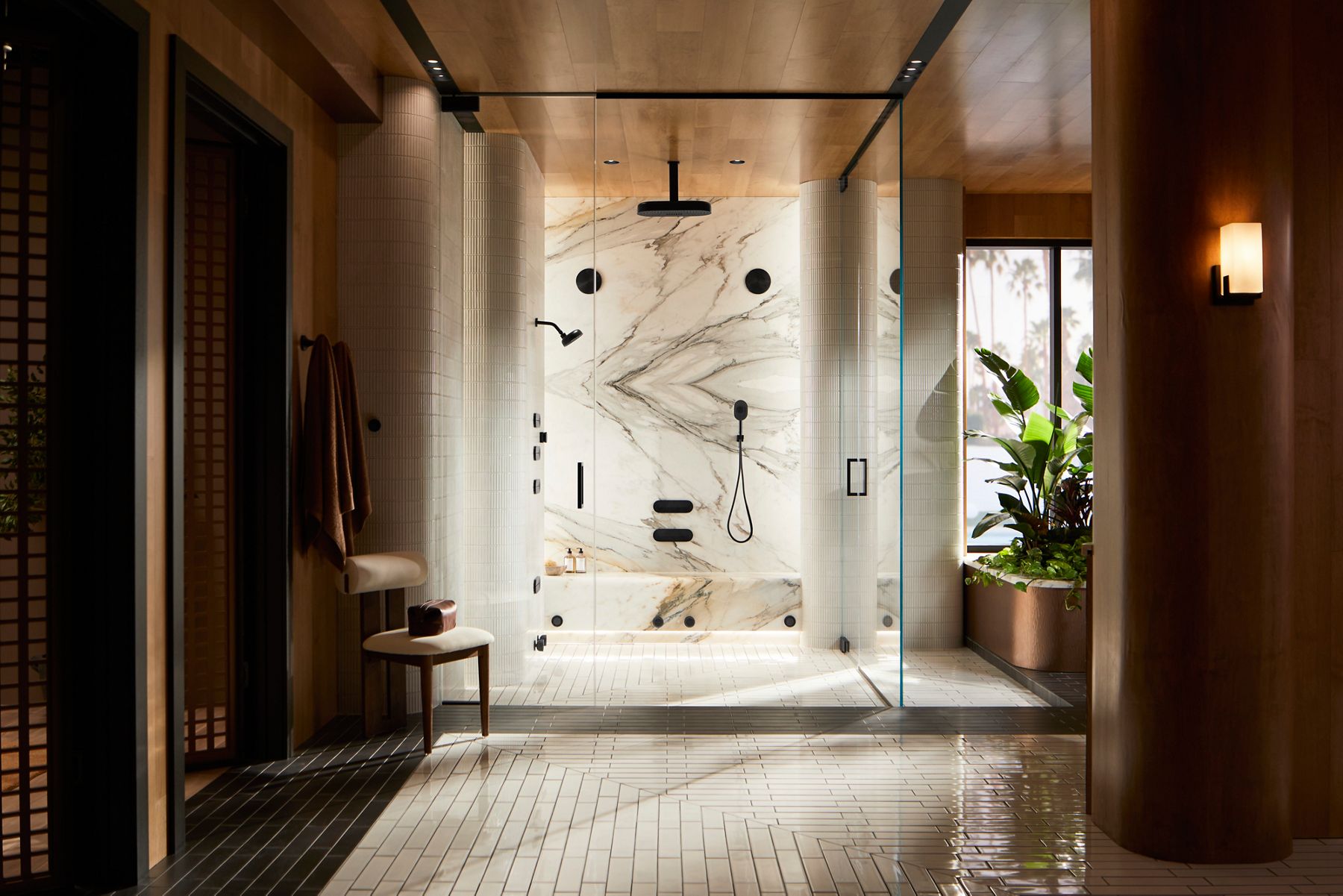 Luxurious modern bathroom with a large glass-enclosed shower and warn ambient lighting.
