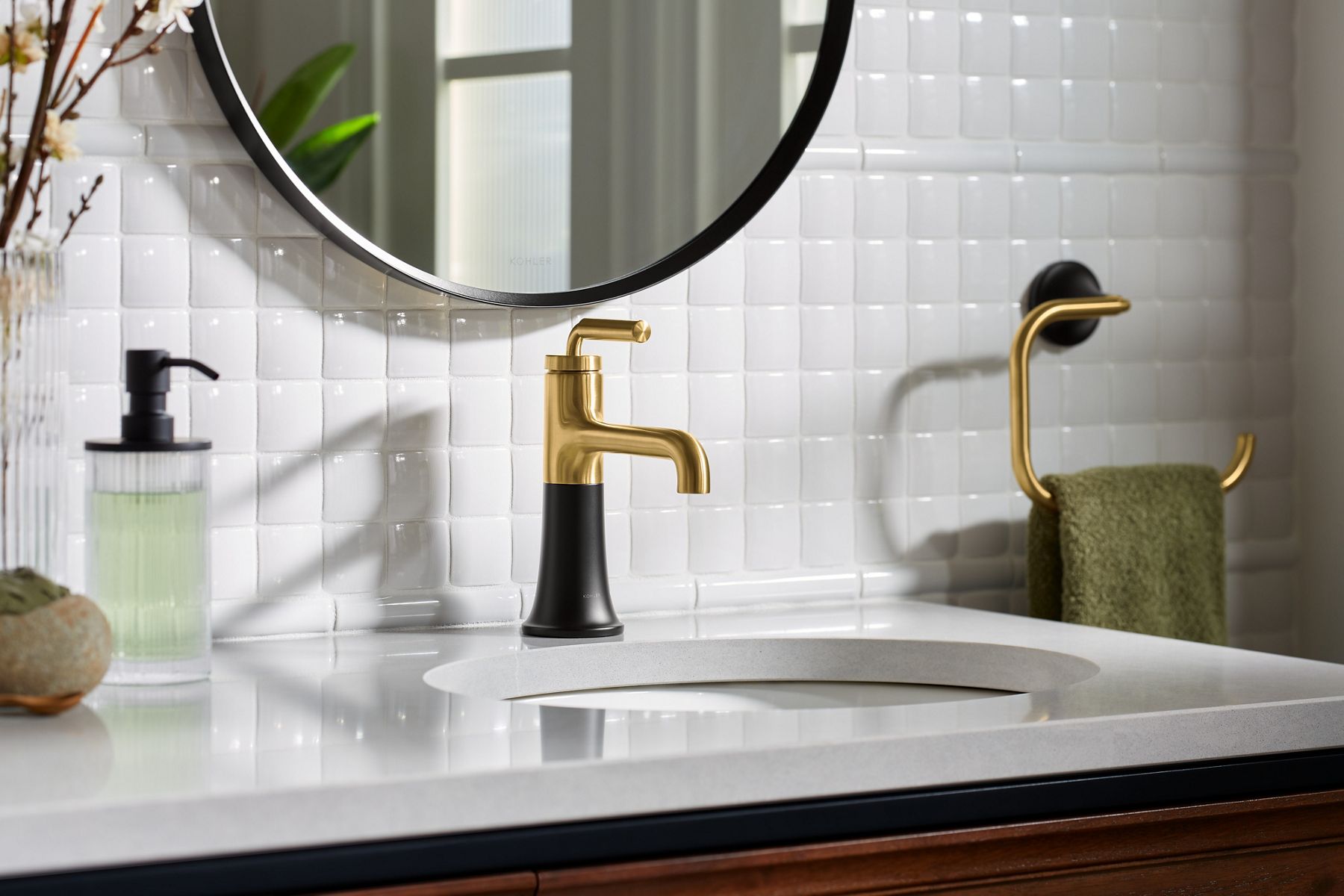 Single-hole faucet with gold and black finish, combining spout and handle in one unit.