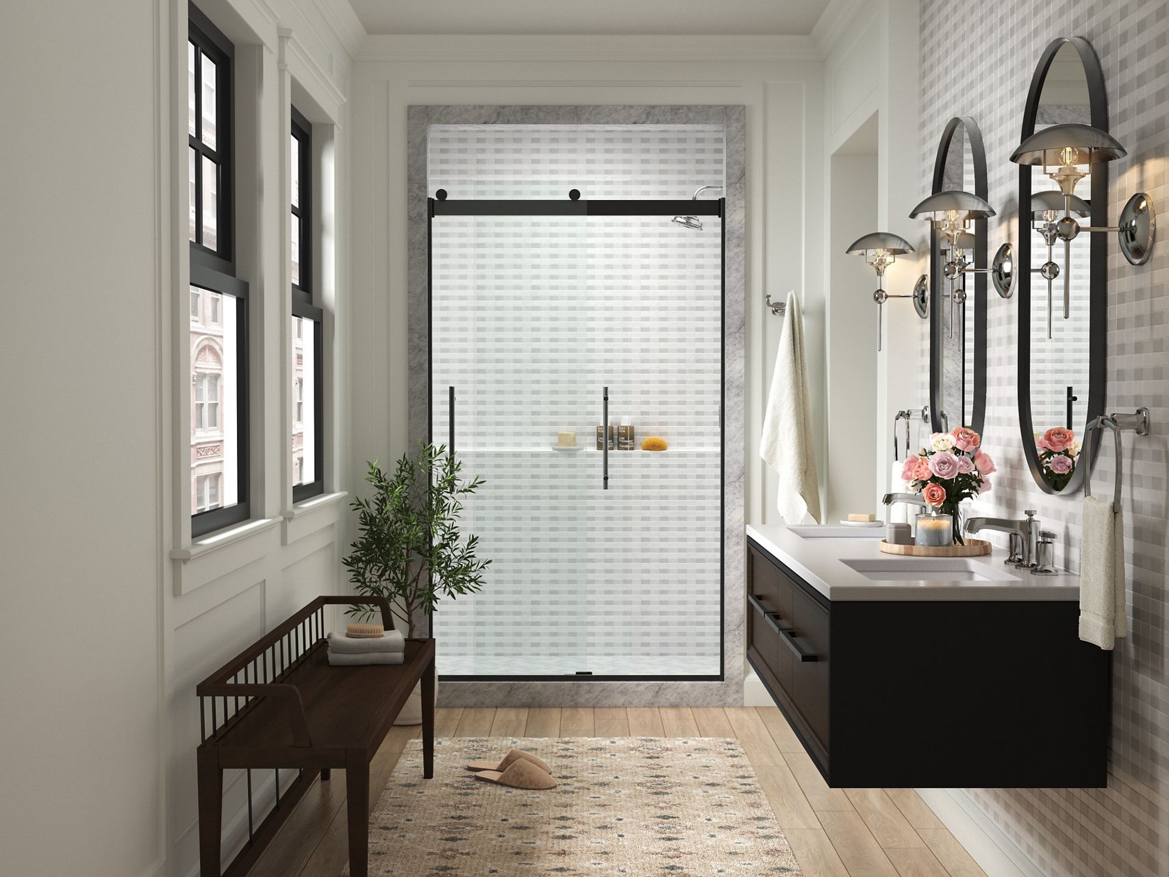 KOHLER sliding shower door with black trim at the end of a white bathroom with beige floor and two windows and black bench on one side with a black wall-mounted vanity and two mirrors on the other side.