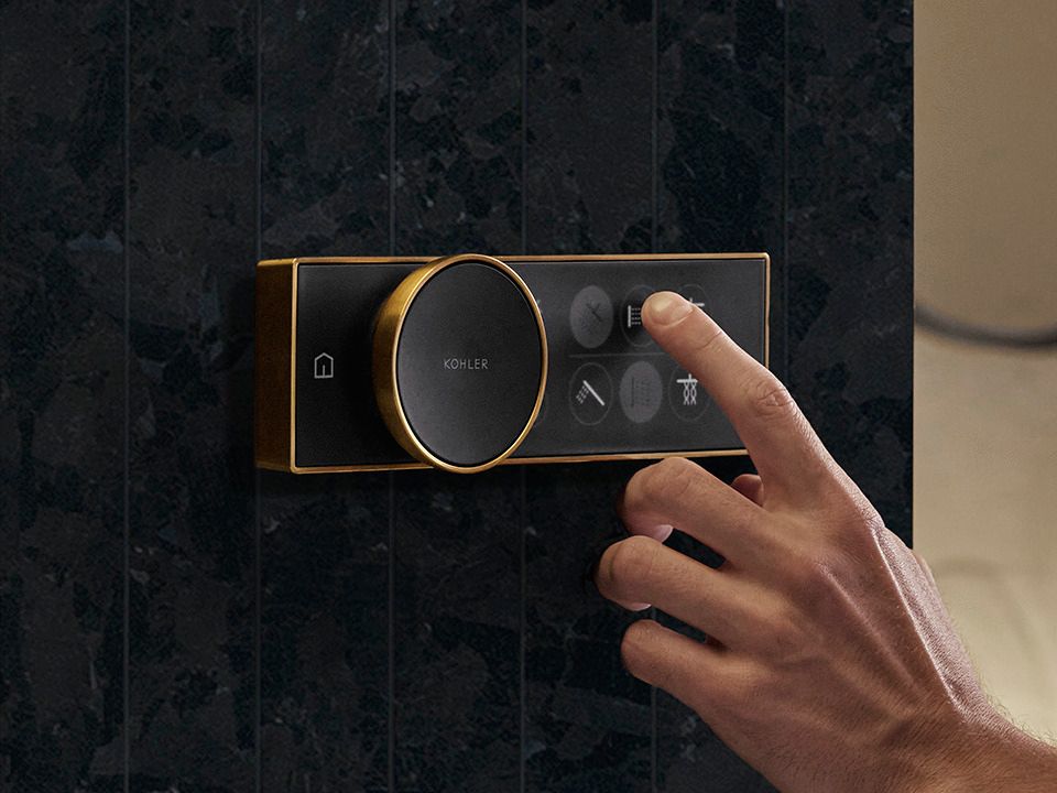 Circular touch control with illuminated icons for shower functions.