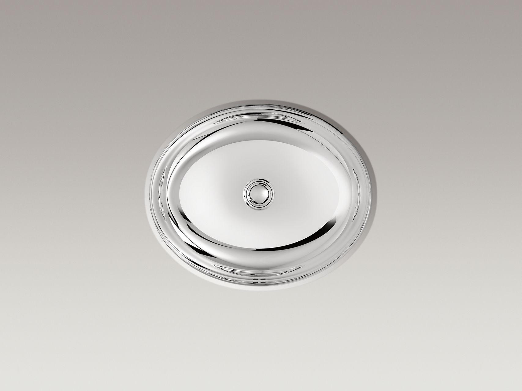 A stainless steel bathroom sink close up.