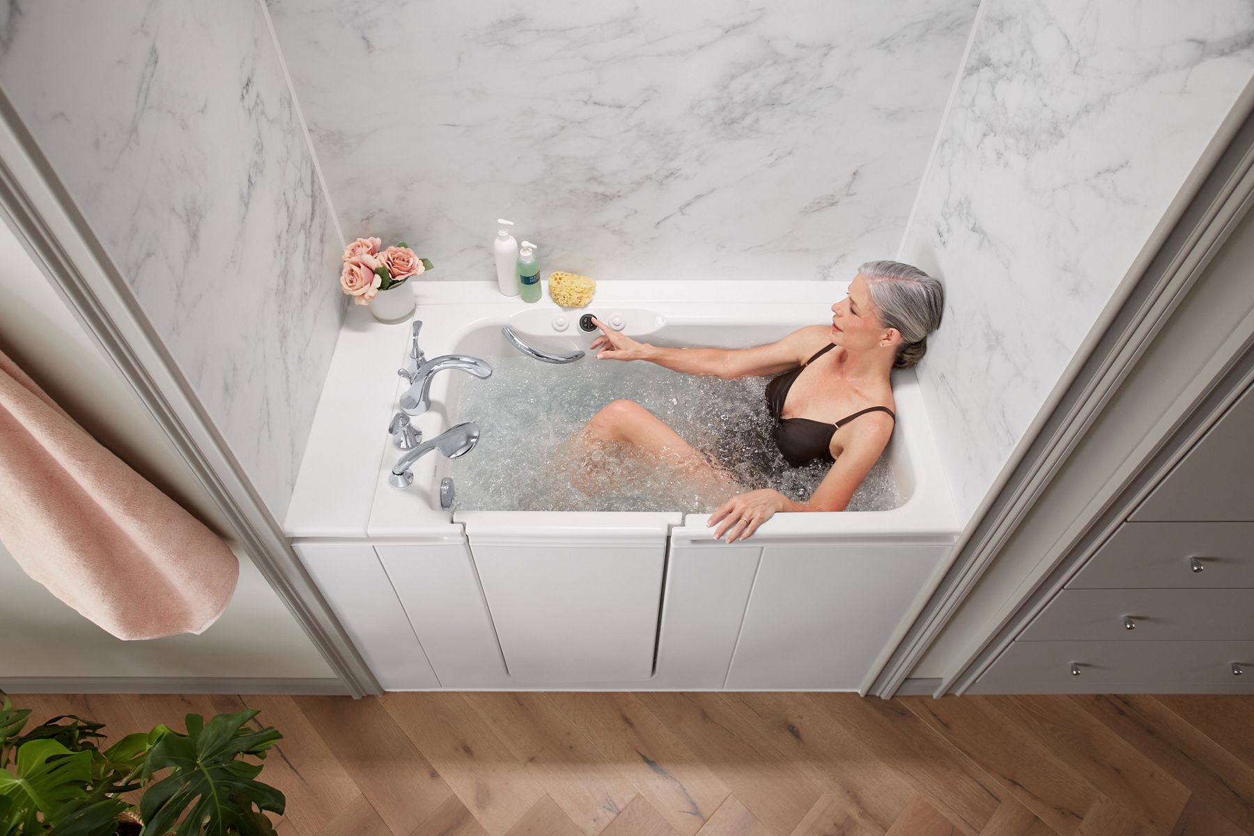 woman clicking dial in a walk-in tub