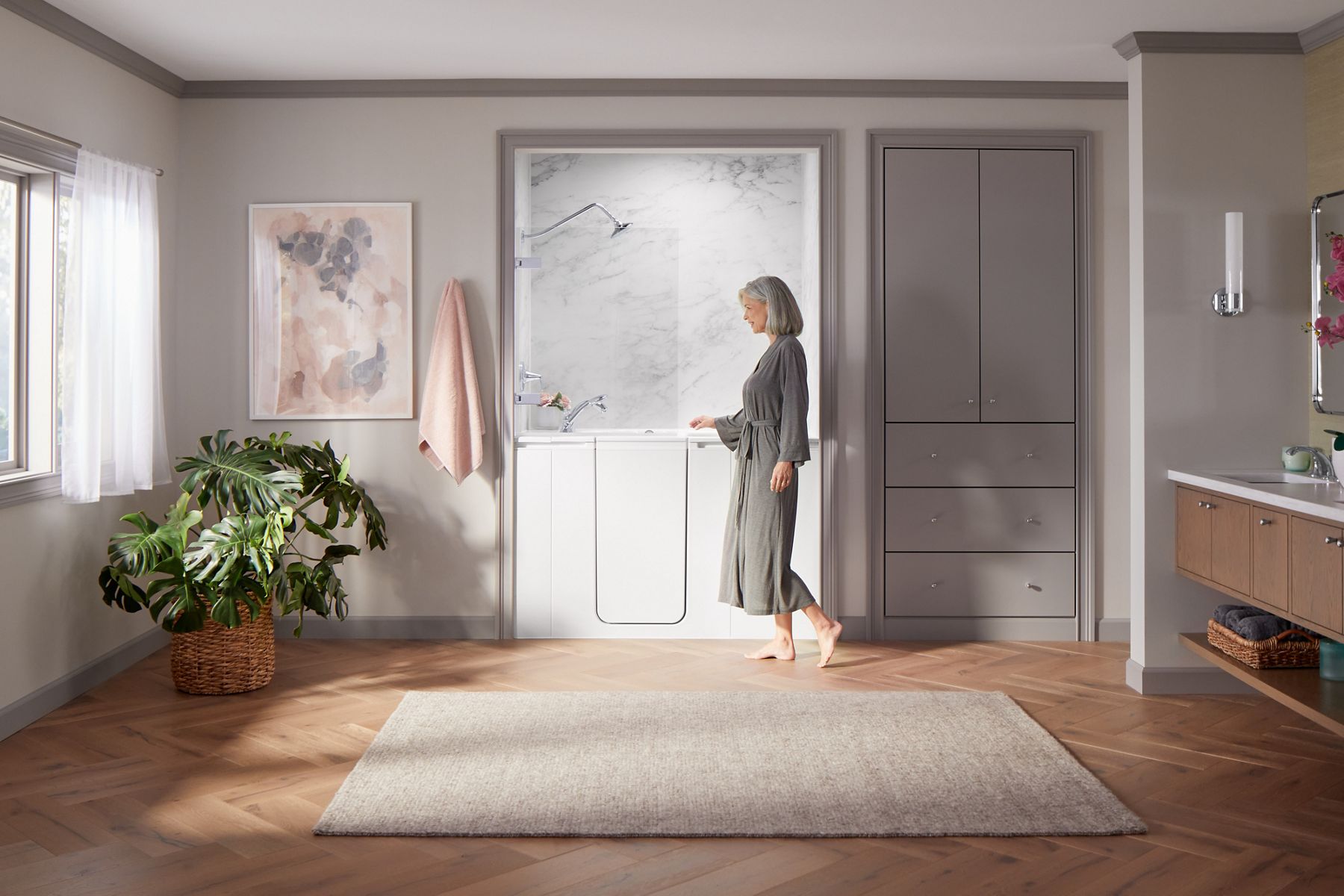 Senior safely entering KOHLER walk-in bath with low step-in threshold