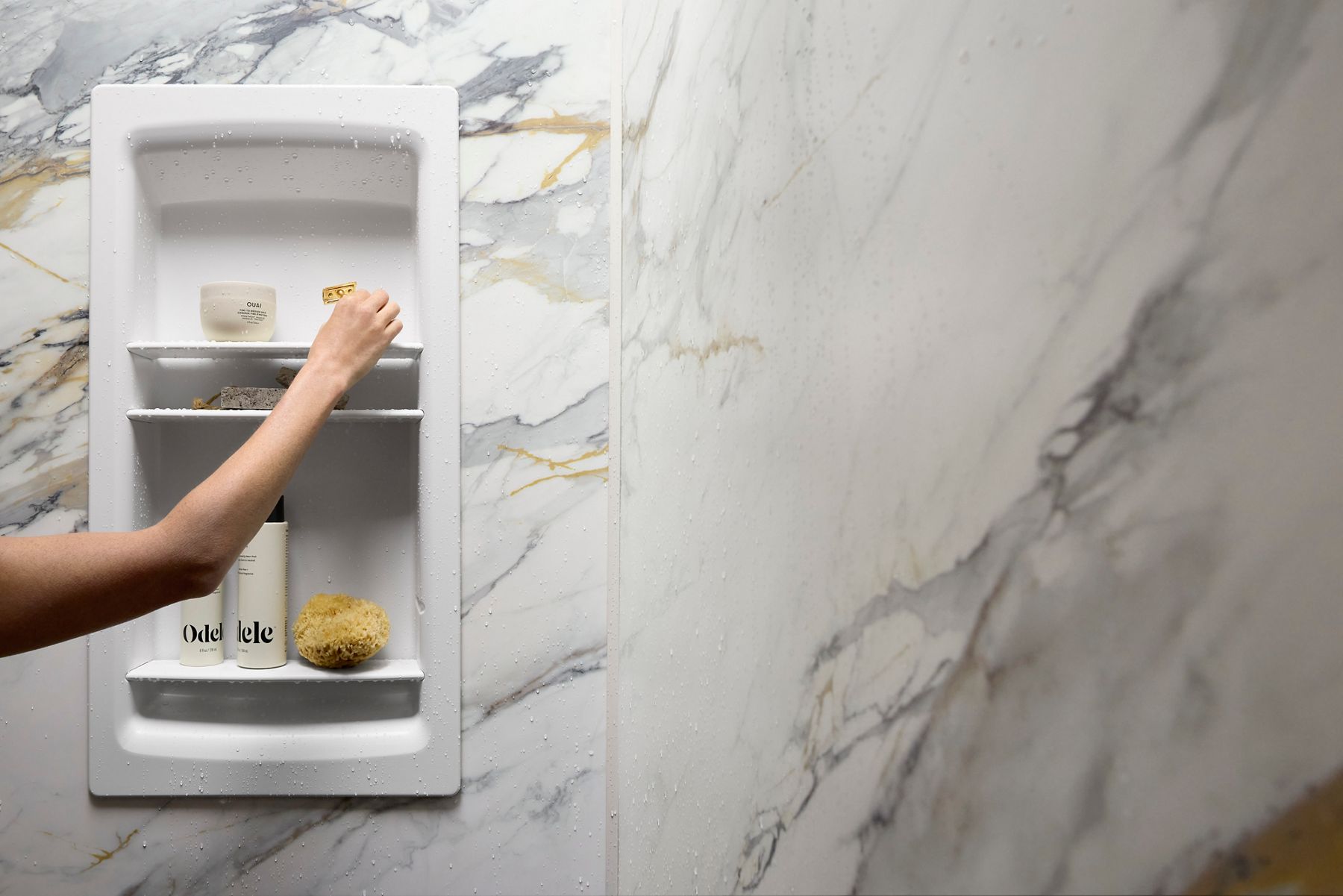 Person cleaning KOHLER shower