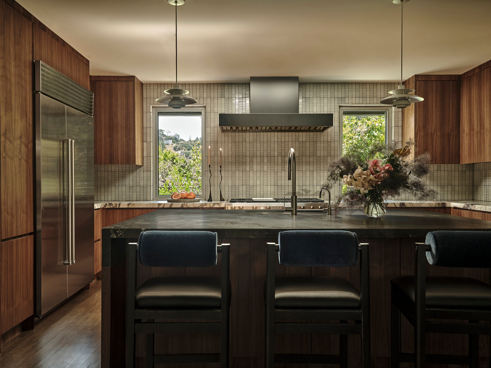 Elegant kitchen interior with ceramic tile backsplash, natural wood tones, and minimalist decor for a warm, modern aesthetic