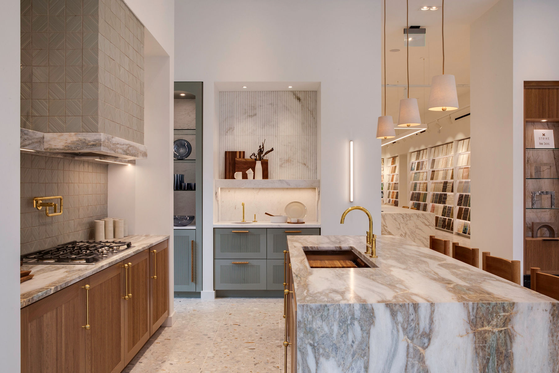 Modern Ann Sacks showroom presenting a designer kitchen with high-end marble finishes and refined lighting accents