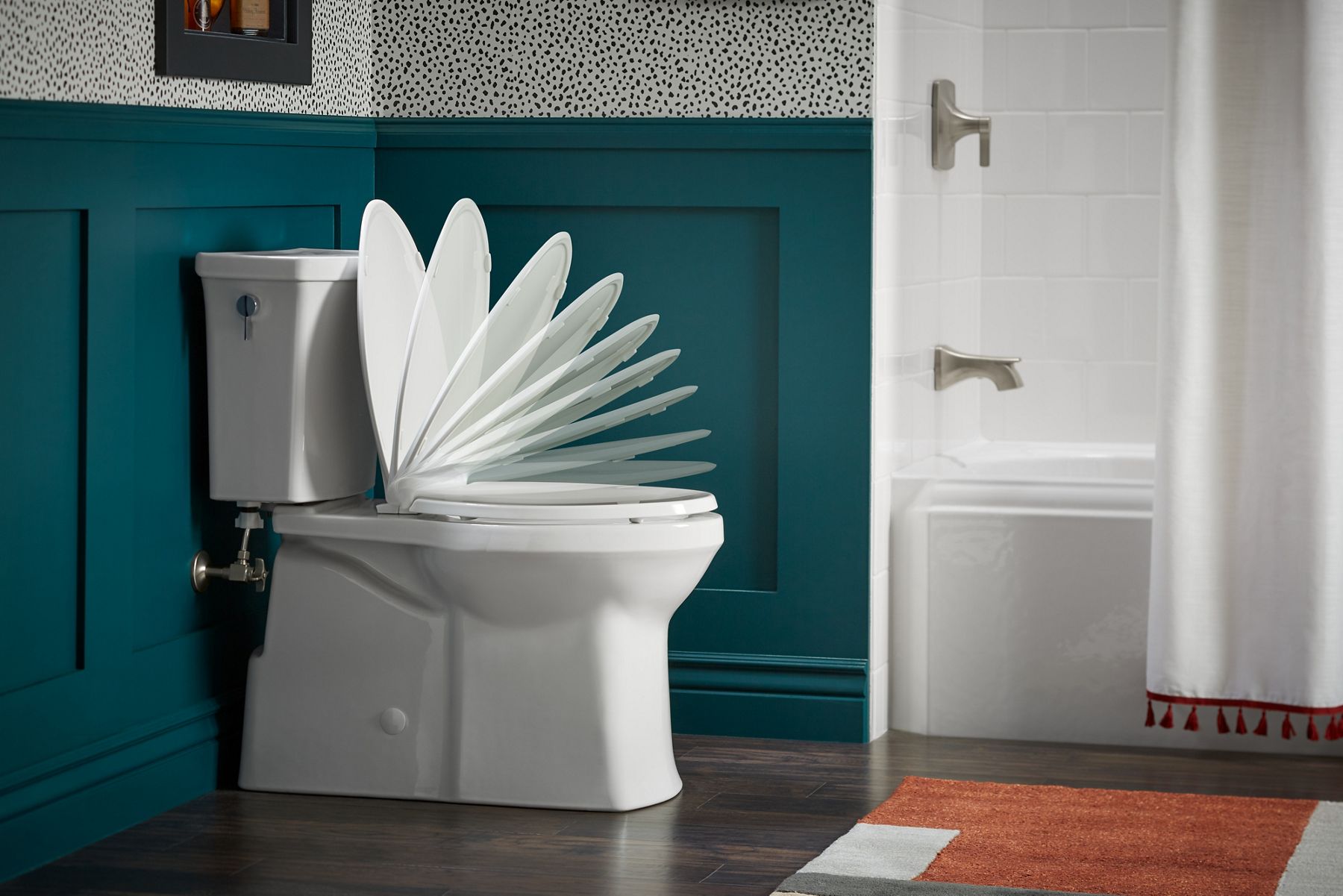 Side view of KOHLER toilet with time-lapse of Quiet-Close toilet seat closing