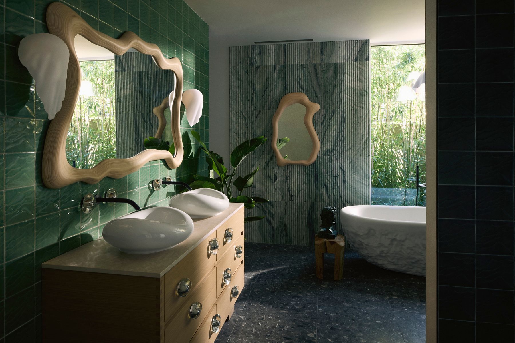 Modern bathroom interior featuring two abstract, wavy-framed mirrors above a double sink with green tiles and natural light streaming through large windows, highlighting the lush greenery outside.