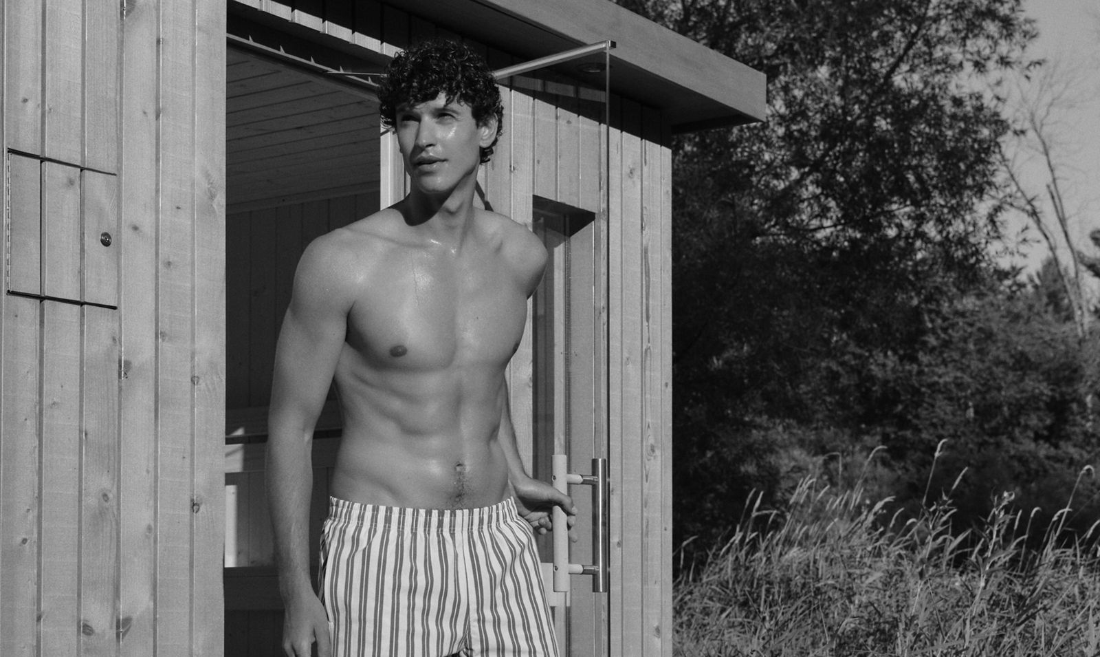 Man walking out of KOHLER Sauna on a sunny day.